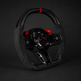 BMW G90 M5 steering wheel with red accents on a dark background